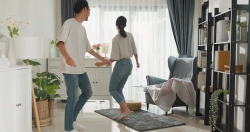 Cheerful Couple Dancing Together in Living Room