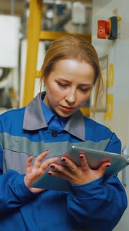 Technician Engineer Woman in Production Workshop of Modern Factory Adjusts Equipment Machine