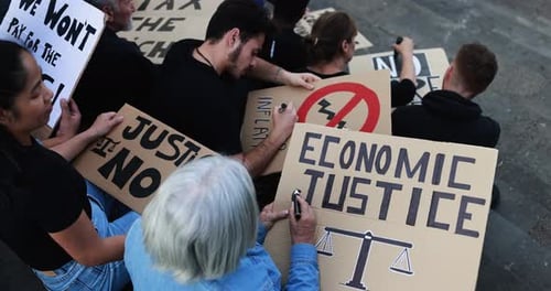 Crowd of multiracial people prepare banners against inflation and financial crisis