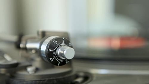 Close-up of a vintage turntable control knob, focus on details and textures, blurred background