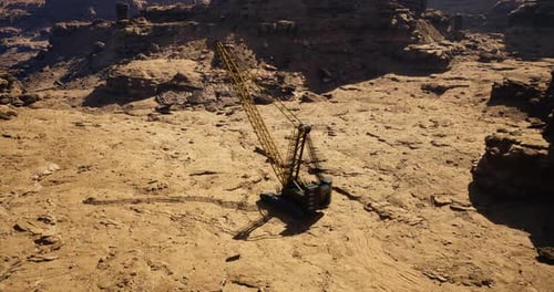 Heavy Machinery Operates on Rocky Terrain During Daylight in a Remote Area