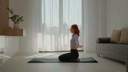 Woman Practicing Yoga at Home