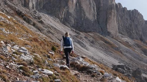 Woman Hiking on Mountain Trail in Sunny Weather