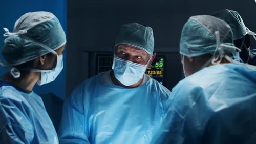 Surgeons Working in Brightly Lit Operating Room