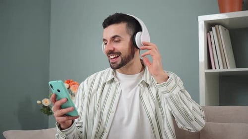 Man Enjoying Music with Headphones and Cell Phone