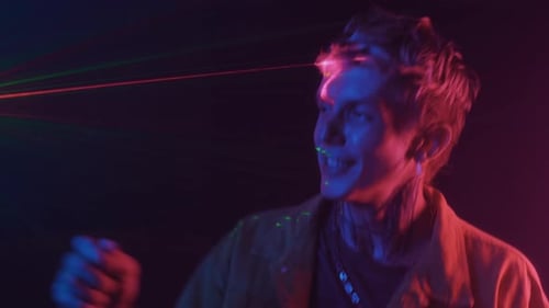 Young Adult dances under neon lights