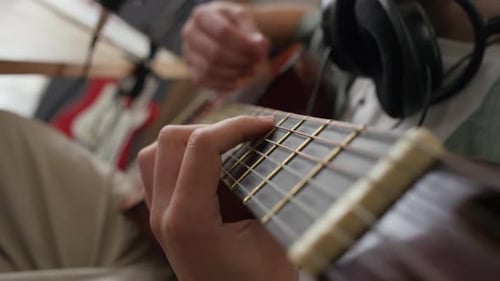 Close-up of Unrecognisable Young Man Playing Acoustic Guitar