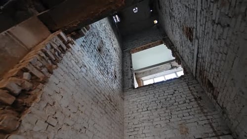 Old shaft of an elevator in the building under demolishing or reconstruction.