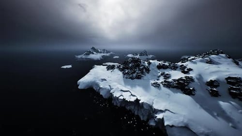 Dramatic Arctic Ocean Landscape with Snowy Islands Under Stormy Sky