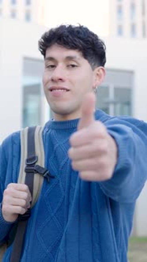 Smiling Young Adult Giving Thumbs Up on Campus