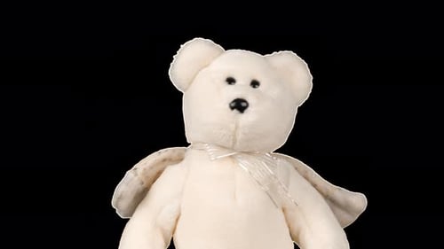 Stuffed and fluffy teddy bear toys with angel wings playing and dancing. Alpha channel included.