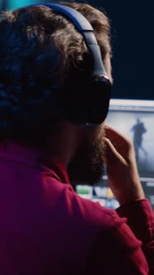 Vertical Video Post Production Studio Employee Working with Raw Footage While Listening Music in