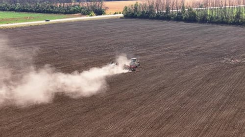 Tractor Plowing Field and Add Nitrogen Fertilizer for Agricultural Crops