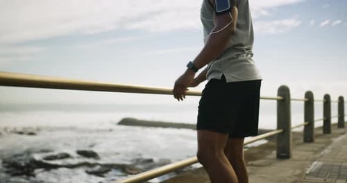 4k video footage of a handsome young man working out on the pavilion at the beach