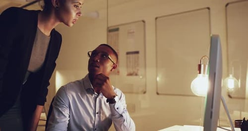 4k video footage of a businessman and businesswoman working together in the office