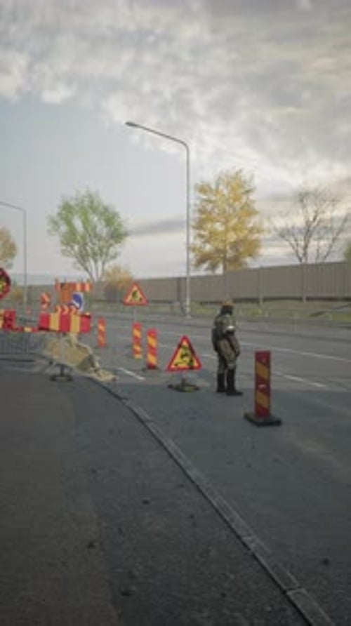 Road Worker Managing Traffic and Construction Near City Highway at Sunset