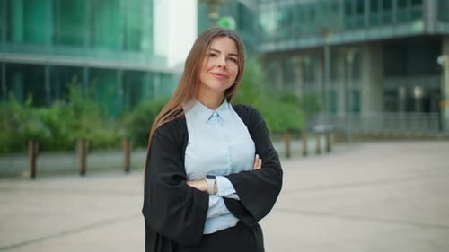 Beautiful Woman in Business Attire Standing Near a Glass Business Building