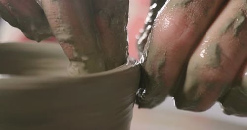 Artist's Hands Forming Clay on Pottery Wheel