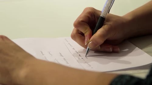 Close up Hand Writes on White Paper