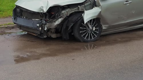 A Car That Has Been Severely Damaged Following a Collision on the Busy Street Causing Significant