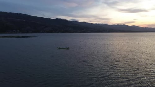 aerial view of a fisherman on his boat in the lake