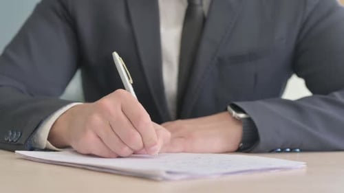 Close up of Businessman Writing Letter, Doing Paperwork