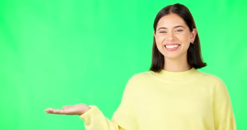 Happy woman, hand and green screen for product placement, advertising or marketing against studio