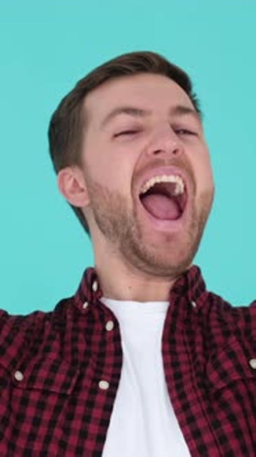 Young Adult Man Yelling up into Camera