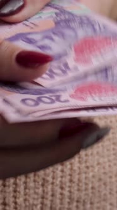 Close Up of a Hand Counting Stack of Currency