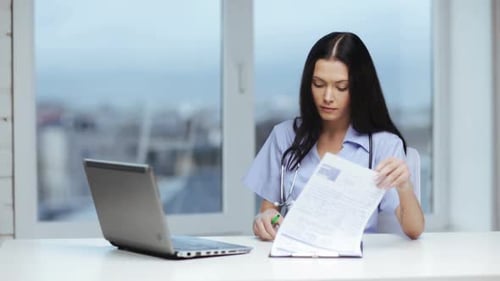 Female Doctor Prescribing with Laptop