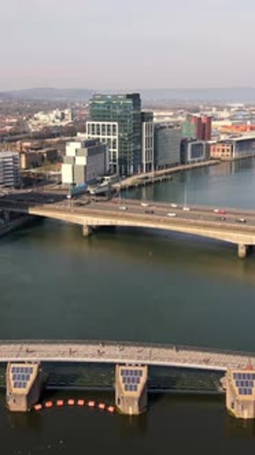 Advancing 60FPS vertical social ratio aerial video of the River Lagan and Lagan Footbridges
