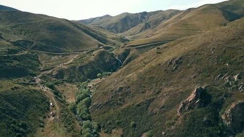 Picturesque Waterfall Flows in Mountainous Rural Landscape