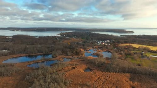 An aerial view over a salt marsh in Greenport, NY by the Long Island Sound on a beautiful day with b