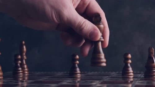 Person Moving Chess Piece