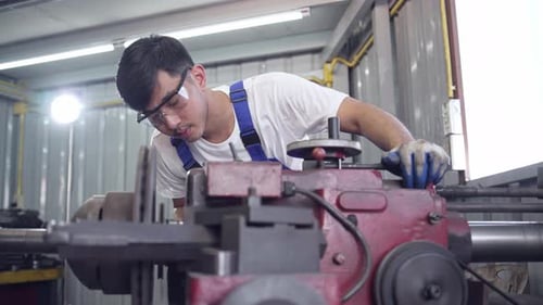 Diversity mechanic worke using metal lathe machine operate tool in the factory