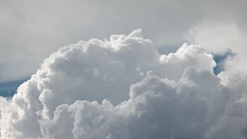 Cumulus clouds moving through the sky with zoomed view