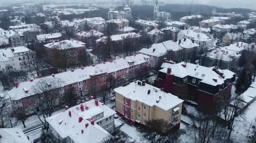 Aerial Drone Flying Over Snowy European City Rooftops Media