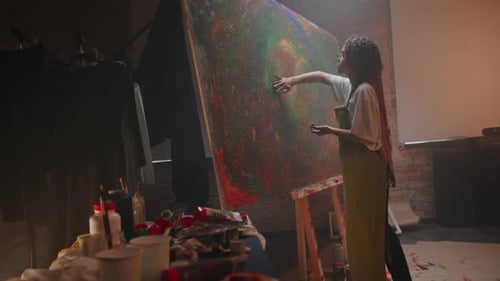 Young Woman Painting Abstract Art in Studio