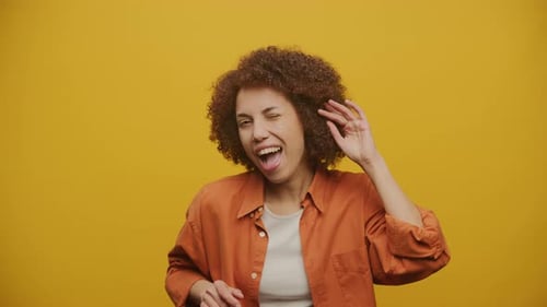 Young Woman Smiling and Dancing in Studio Setting