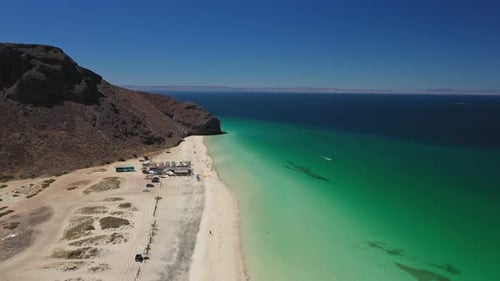 Turquoise Water Meeting Sandy Beach on Sunny Day