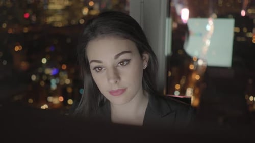 Young Confident Woman Working in Modern Office on Computer Desk At Night