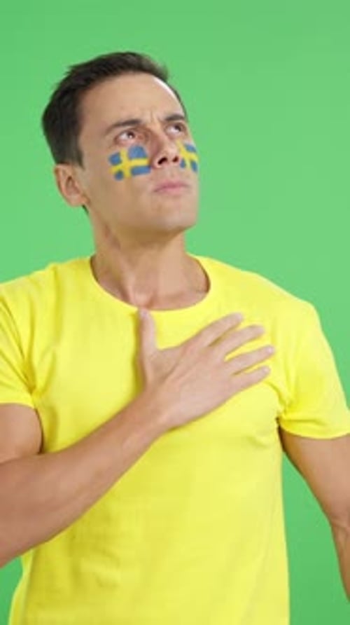 Man Listening to the Sweden National Anthem with Solemnity