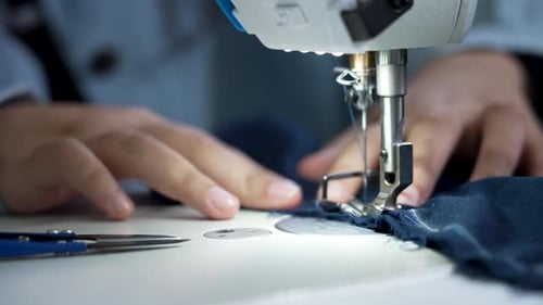 Hands Seam Stitching Fabric on Sewing Machine