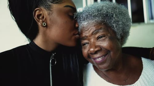 Affectionate Young Woman and Gray-Haired Senior Woman Hugging