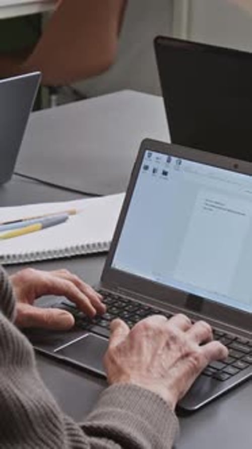 Vertical Shot of Unrecognizable Man Typing Text in Computer Literacy Class