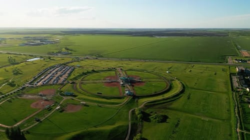 Sunset Drone Orbit on Sports Complex People Playing on an Outdoor Soccer Field