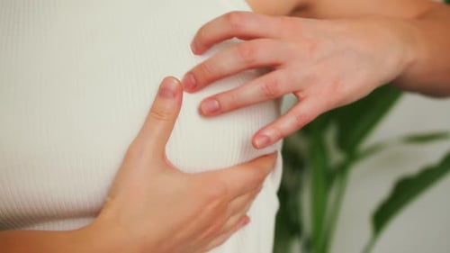 Woman is Performing a Selfexamination Checking Breasts By Palpation to Feel for Any Lumps