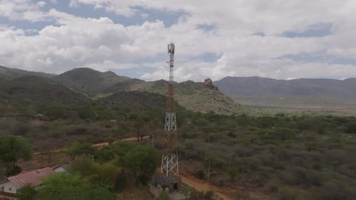 Aerial view of cell tower with mountains, Kenya.