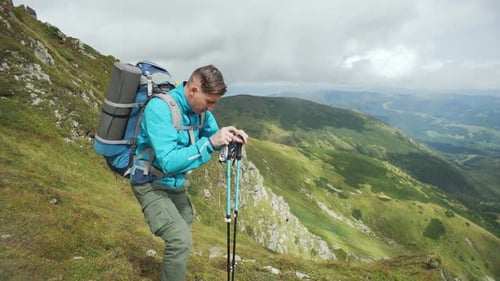 The Man Conquers the Mountain and Takes a Break for a Photo