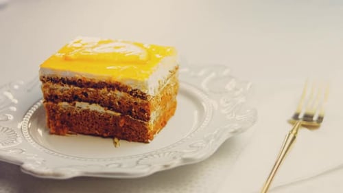 Delicious Layered Cake with Yellow Glaze and Fork